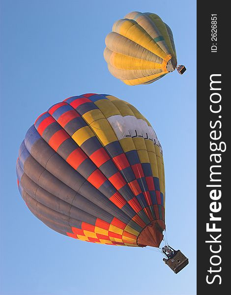 Two hot air balloons flying side by side. Two hot air balloons flying side by side