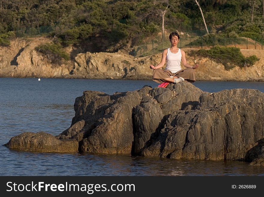 Woman making of yoga at the seaside. Woman making of yoga at the seaside