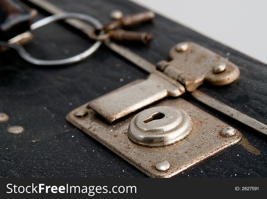 Black suitcase keyhole in rusty chrome