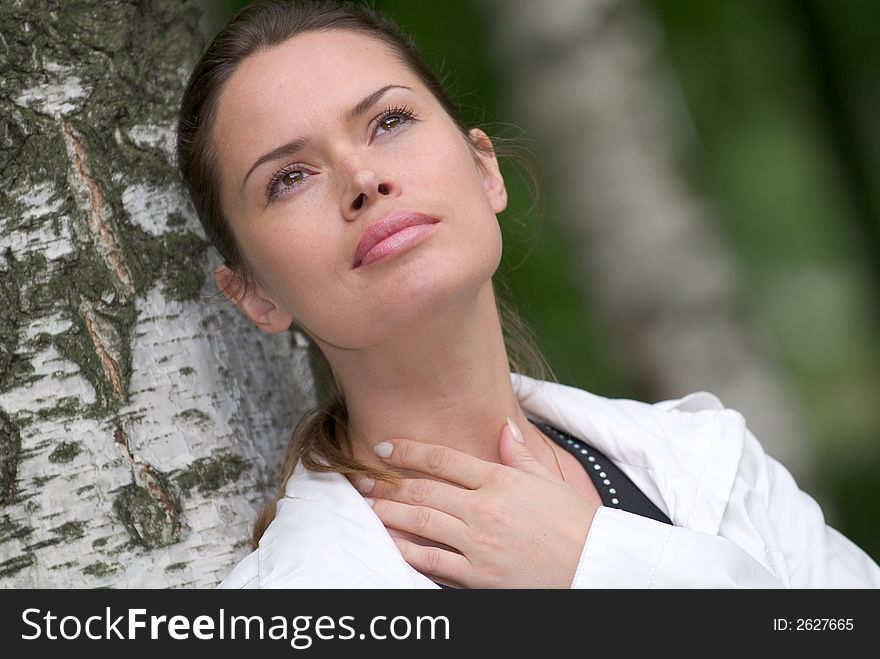 Beautiful lady relaxing outdoors in a park. Beautiful lady relaxing outdoors in a park