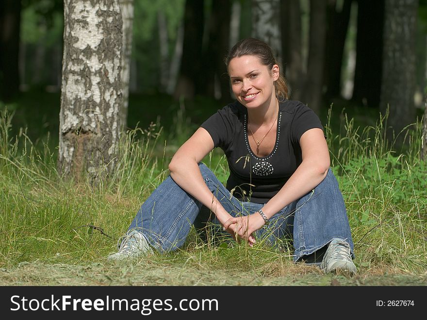 Beautiful lady relaxing outdoors in a park. Beautiful lady relaxing outdoors in a park