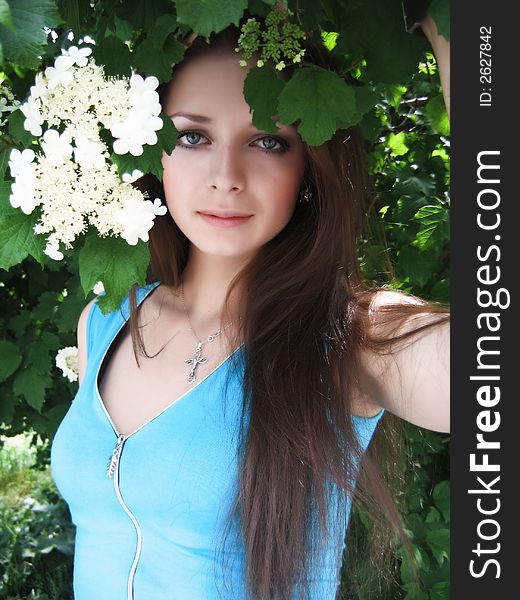 Long-haired beautiful girl in white flower blossom. Long-haired beautiful girl in white flower blossom