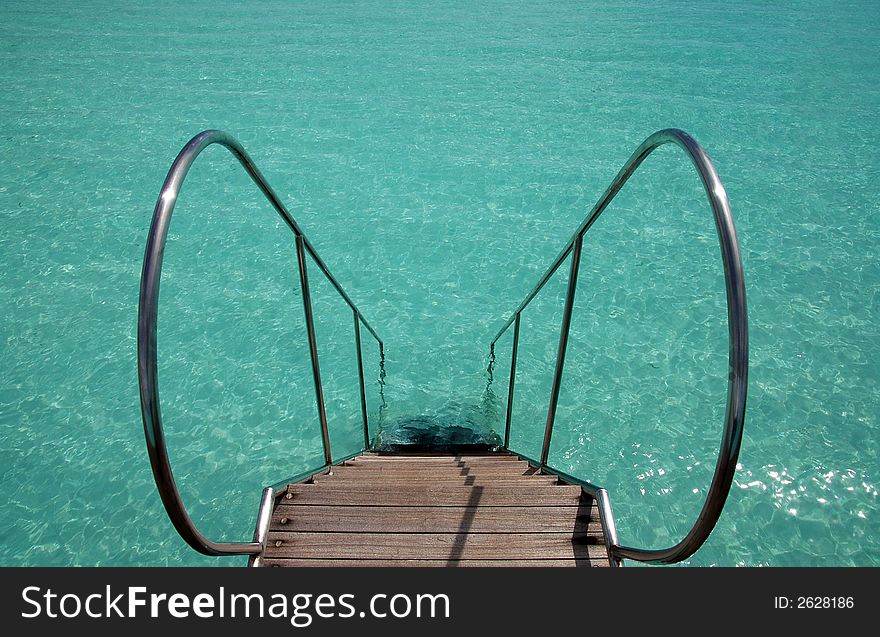 Ladder into the turquoise indian ocean. Ladder into the turquoise indian ocean