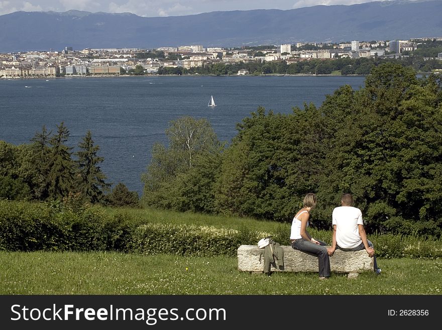 A young couple enjoying the view of lake Geneva. A young couple enjoying the view of lake Geneva