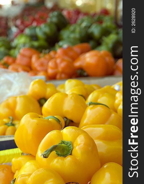 Ripe yellow peppers on display.