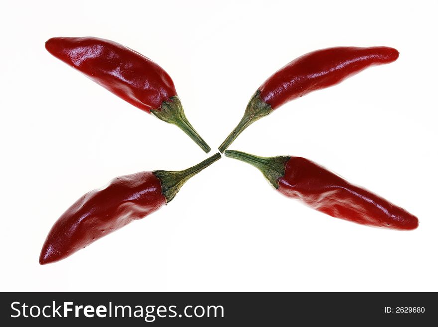 Four red chillies, presented for consumption. Four red chillies, presented for consumption.