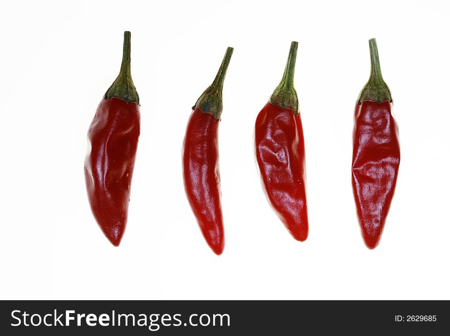 Four red chillies, presented for consumption. Four red chillies, presented for consumption.