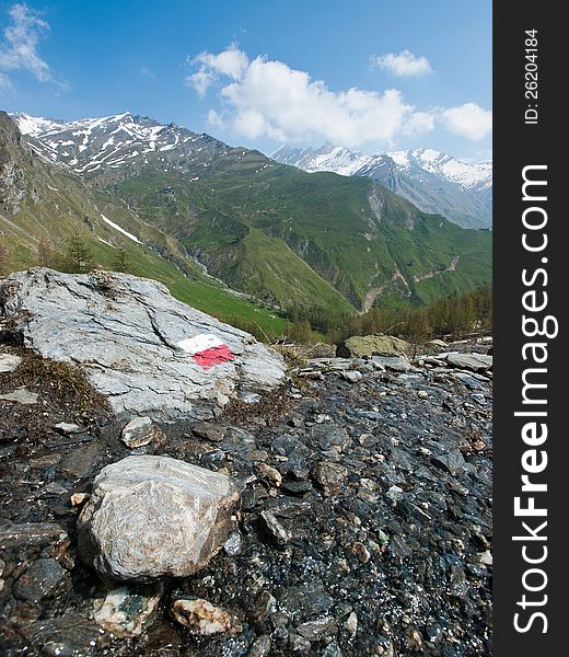 An indication on a rock to show the right direction on a mountain path. It can be used as a concept related to finding your own way and more. An indication on a rock to show the right direction on a mountain path. It can be used as a concept related to finding your own way and more.