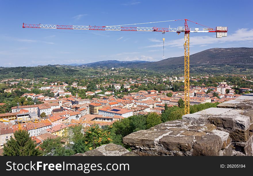 Large crane over a landscape view of the town of Gorizia and its surroundings. Large crane over a landscape view of the town of Gorizia and its surroundings