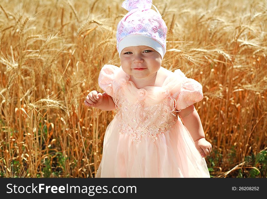 Portrait of little child girl in wheat field