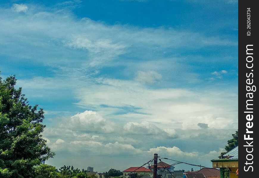 green natural scenery with beautiful and cool clouds that are pleasing to the eye