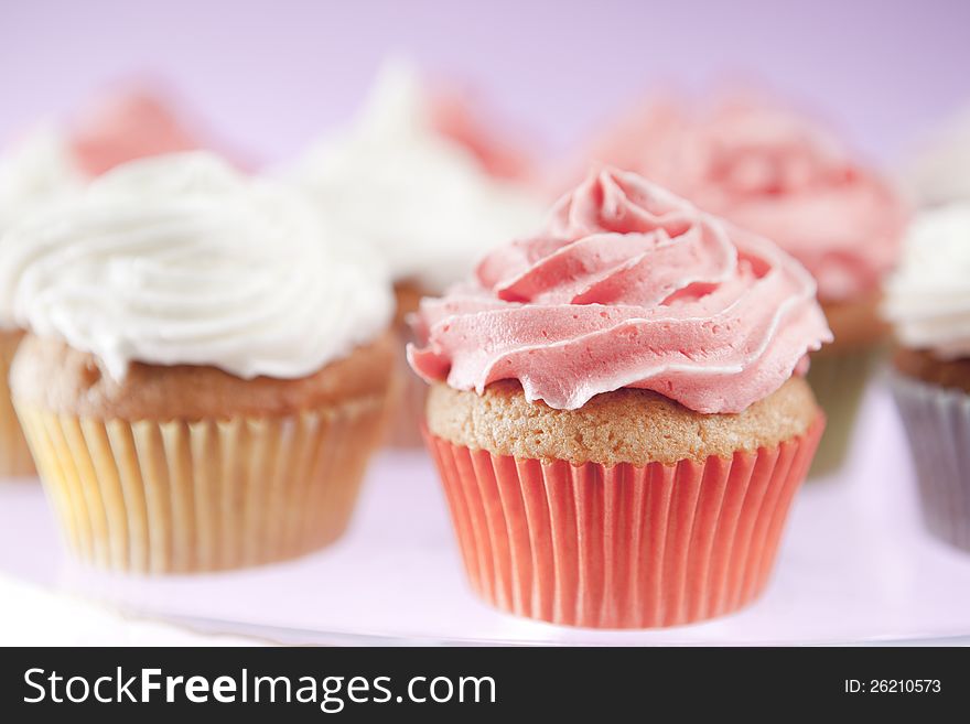 Homemade pink and white cupcakes on the plate
