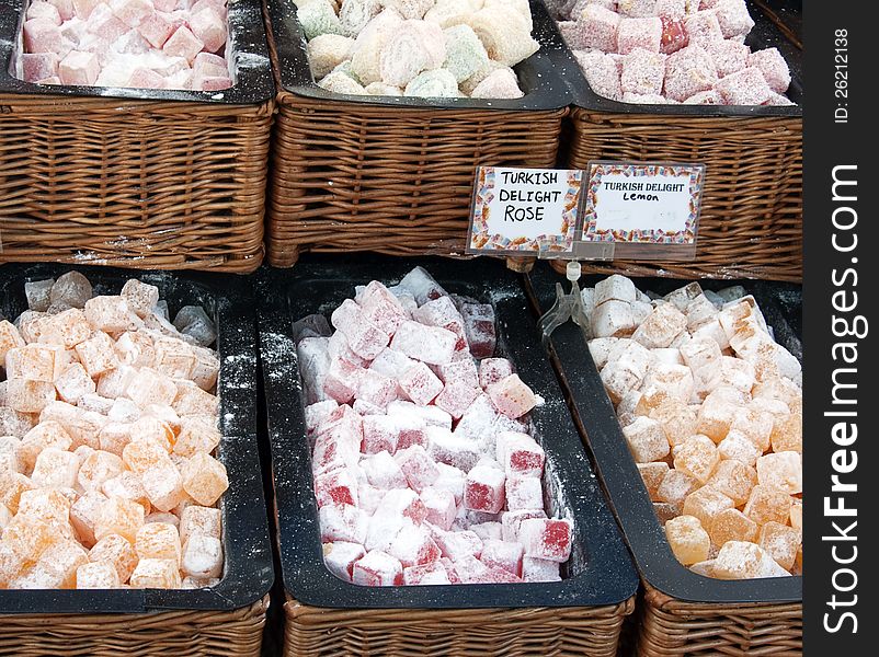 Assorted turkish delight sweet for sale displayed in woven baskets at the market stall.