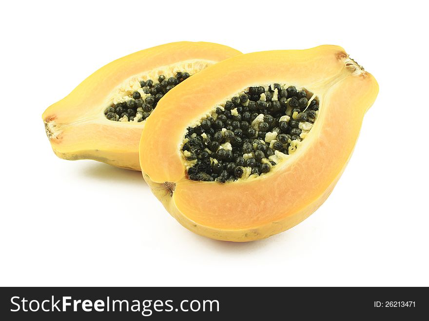 Two halves of tasty papaya on white background. Two halves of tasty papaya on white background