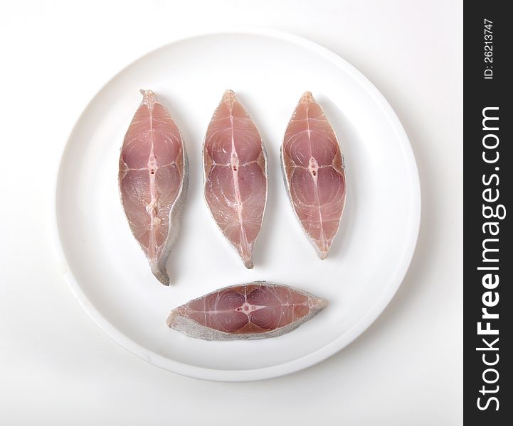 Sliced fish on white plate