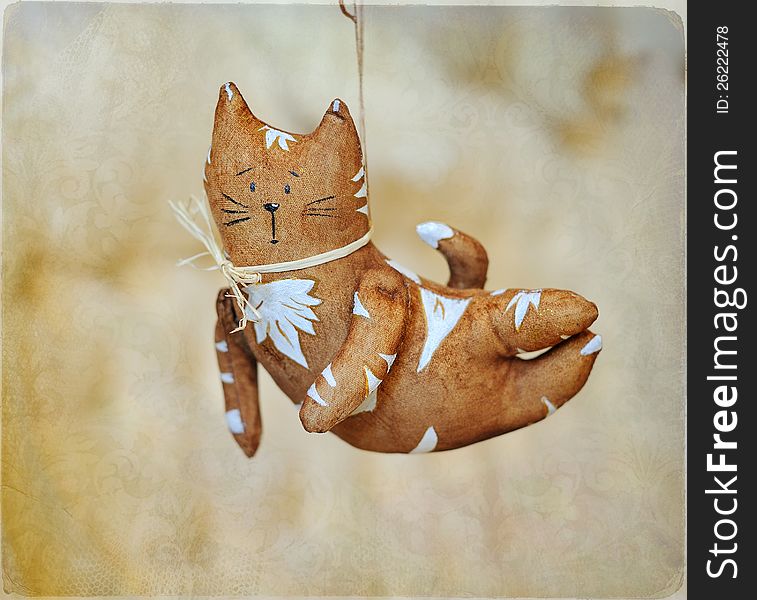 Flying brown cat with white drawing and a bow. Flying brown cat with white drawing and a bow