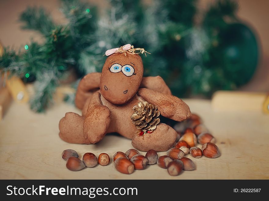 Under a green fir-tree on nuts the wonderful brown toy sits. Under a green fir-tree on nuts the wonderful brown toy sits