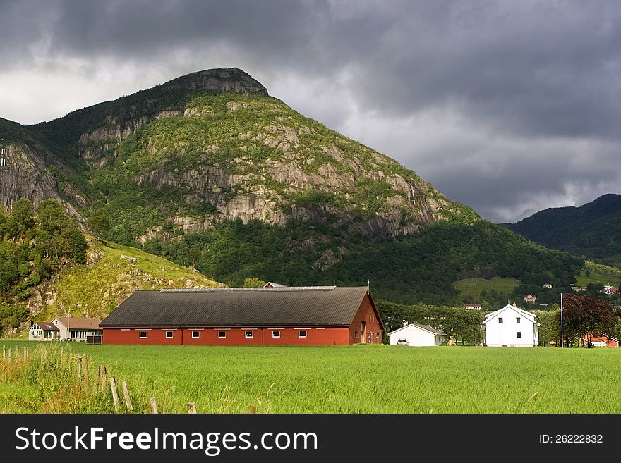 A village surrounded by green forested mountains in Norway. A village surrounded by green forested mountains in Norway.