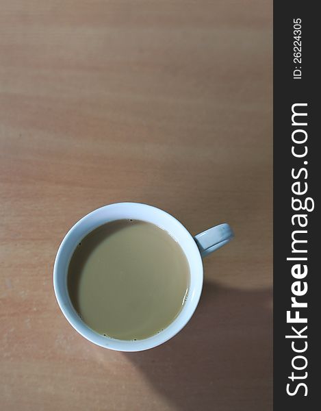 The coffee cup on wooden table. The coffee cup on wooden table.