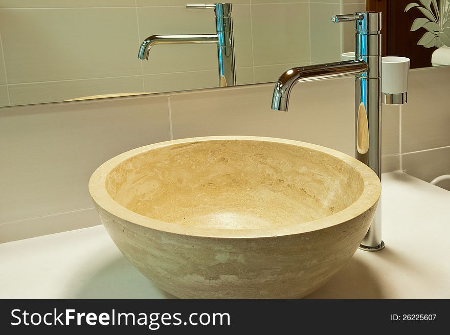 Sink and faucet in modern style in a wooden house, close-up. Sink and faucet in modern style in a wooden house, close-up