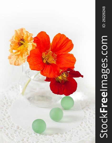 A bouquet of flowers of nasturtium and decorative glass balls green. A bouquet of flowers of nasturtium and decorative glass balls green