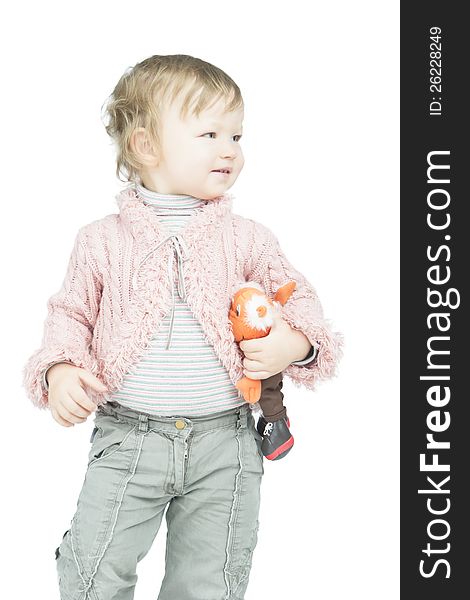 Portrait of little smiling toddler with toy walking along white background