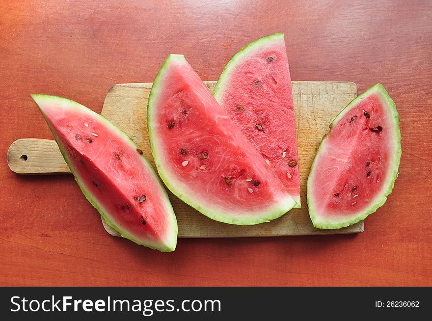Slices of watermelon on a cutting board.