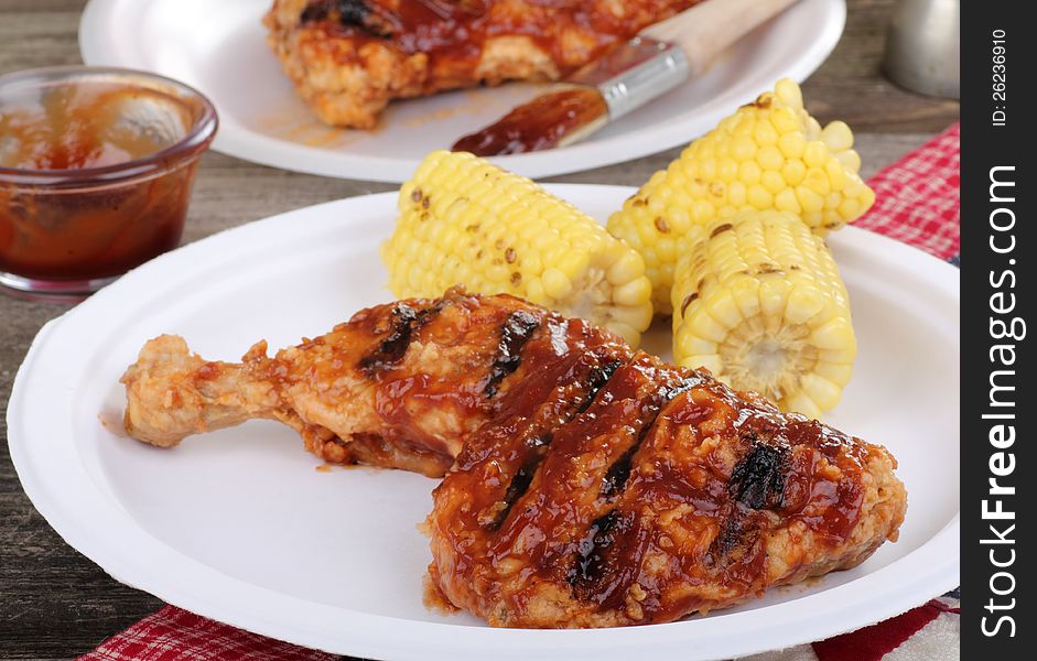 Grilled barbecue chicken and corn on a plate