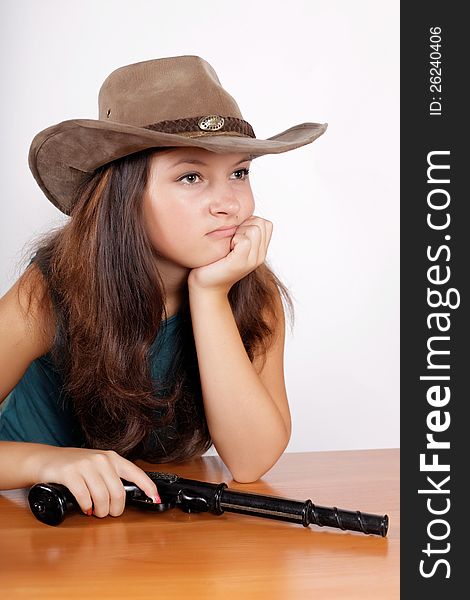 Cowgirl a hat with a gun