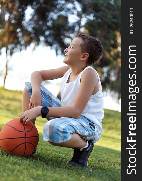 Boy With A Ball In The Fresh Air In The Park