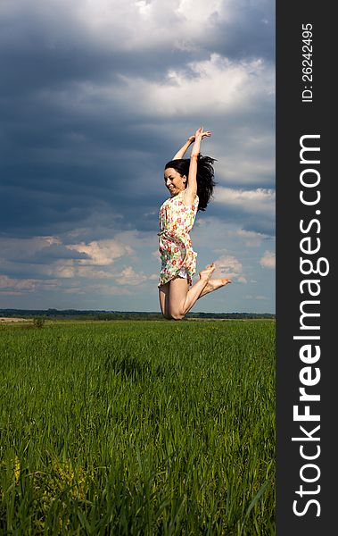 Young girl jumping on the field