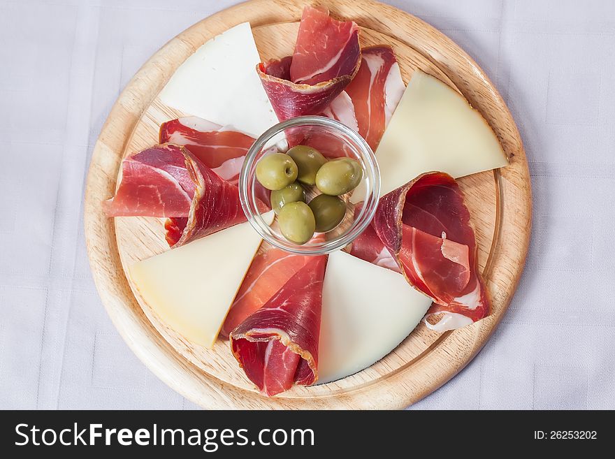 Cheese and bacon platter served with some olives. Cheese and bacon platter served with some olives.
