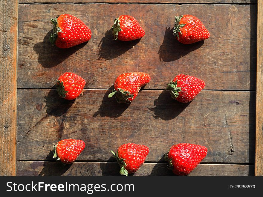 Few freshness red strawberries on wooden surface. Few freshness red strawberries on wooden surface