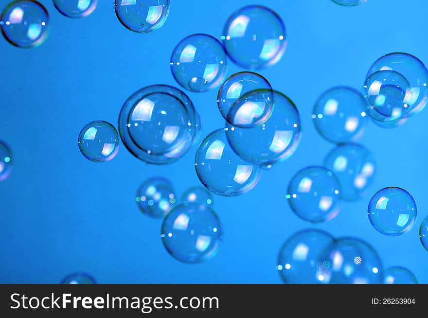 Soap bubbles on blue background