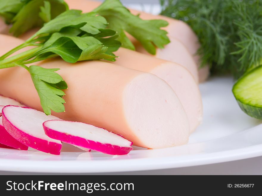 Fresh sausages on a white plate