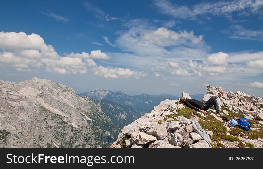 Hiker resting on the top of the mountain in Julian alps. Hiker resting on the top of the mountain in Julian alps