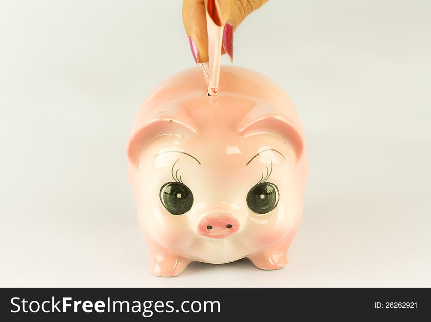 Pink Piggy Bank With Money.