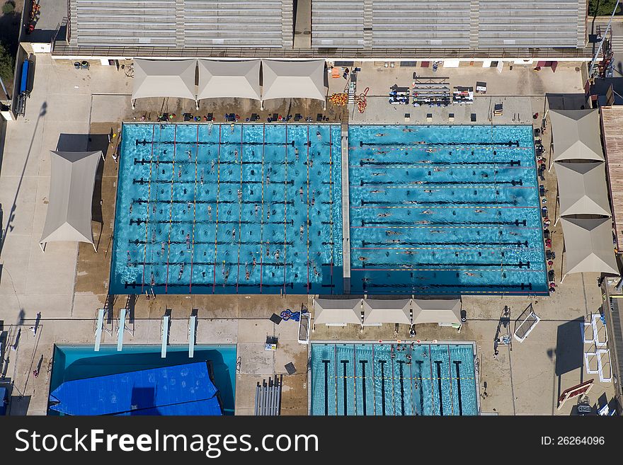 Aerial view of public swimming pool with swimmers