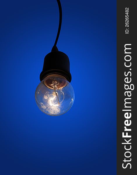 Old light bulb on blue background