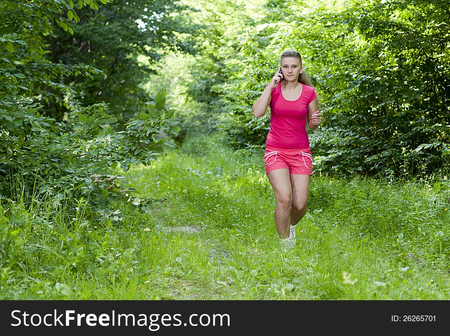 Beautiful, young girl jogging in the woods. Beautiful, young girl jogging in the woods