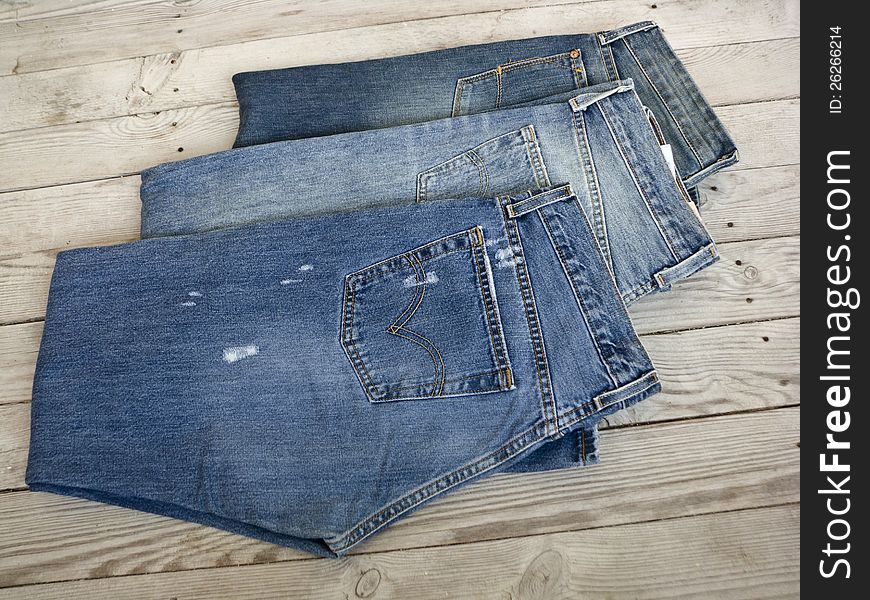 Jeans on a wooden shelf.