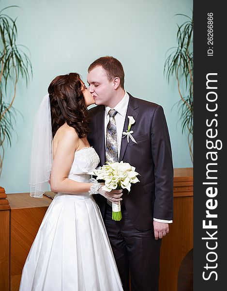 Kiss bride and groom at wedding ceremony