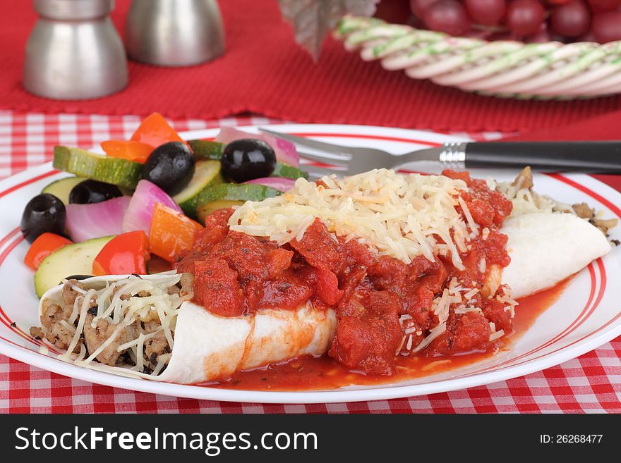 Enchilada covered with tomato sauce and cheese. Enchilada covered with tomato sauce and cheese