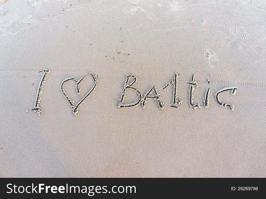 I love Baltic. Inscription on white sand.