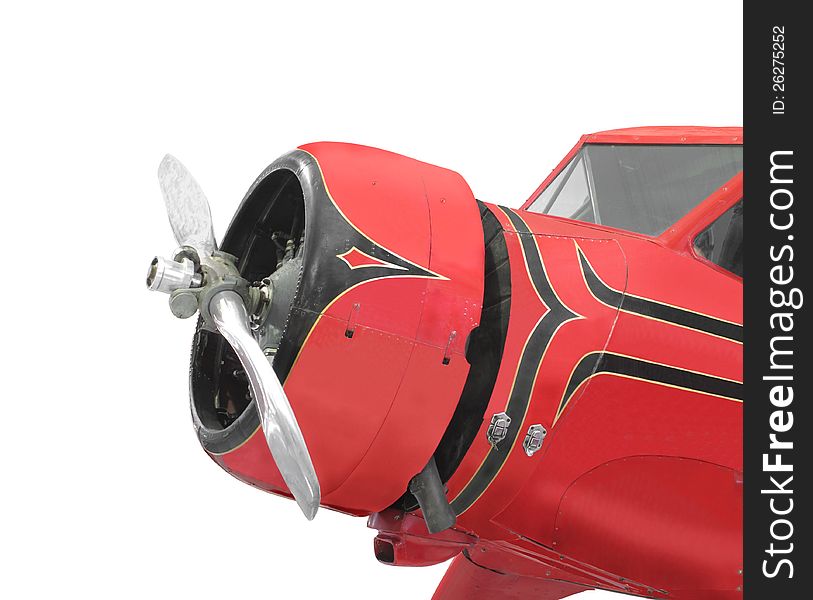 Close-up of the front of a small red airplane with a radial engine, showing the engine, cowl, propeller, and windscreen. Isolated on white. Close-up of the front of a small red airplane with a radial engine, showing the engine, cowl, propeller, and windscreen. Isolated on white.