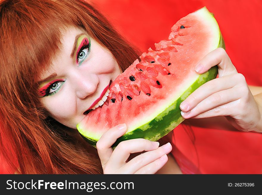 Redhead bright girl enjoying sweet watermelon