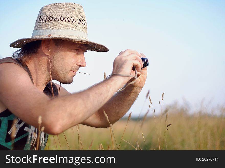 The man in a straw hat with the camera