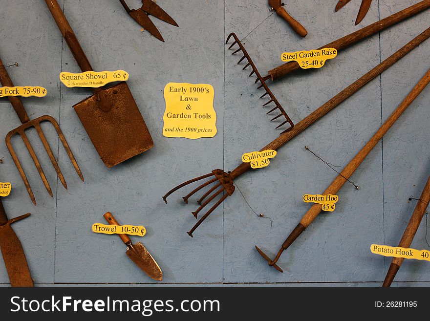 Gray Wall Filled With Old Farm Tools