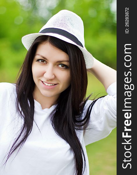 Attractive happy young woman wearing a straw hat. Attractive happy young woman wearing a straw hat