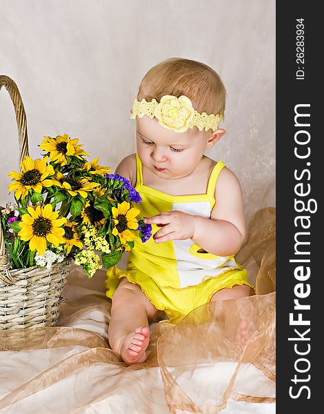 Baby looking and touching the flowers. Baby looking and touching the flowers